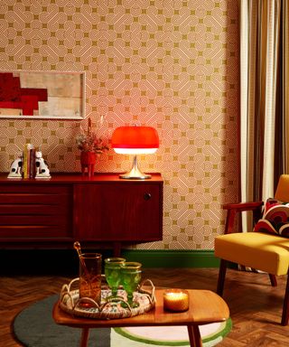A 70s-inspired living room with bold wallpaper and a small wooden table