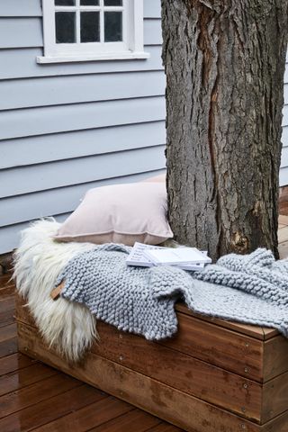 An outdoor seating area built around tree trunk