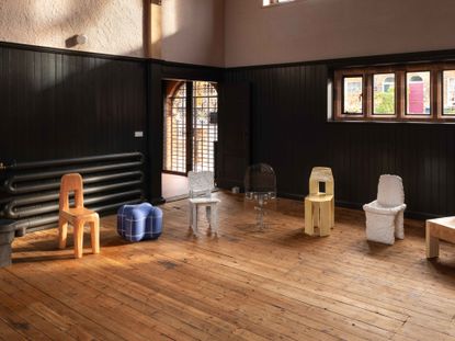 Max Lamb's chairs made of different materials are shown in a circle inside an old church hall
