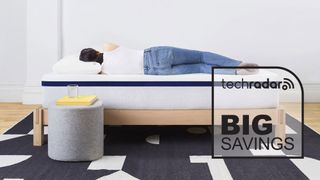 A person lying on the Helix Midnight mattress with a badge overlaid saying "BIG SAVINGS"