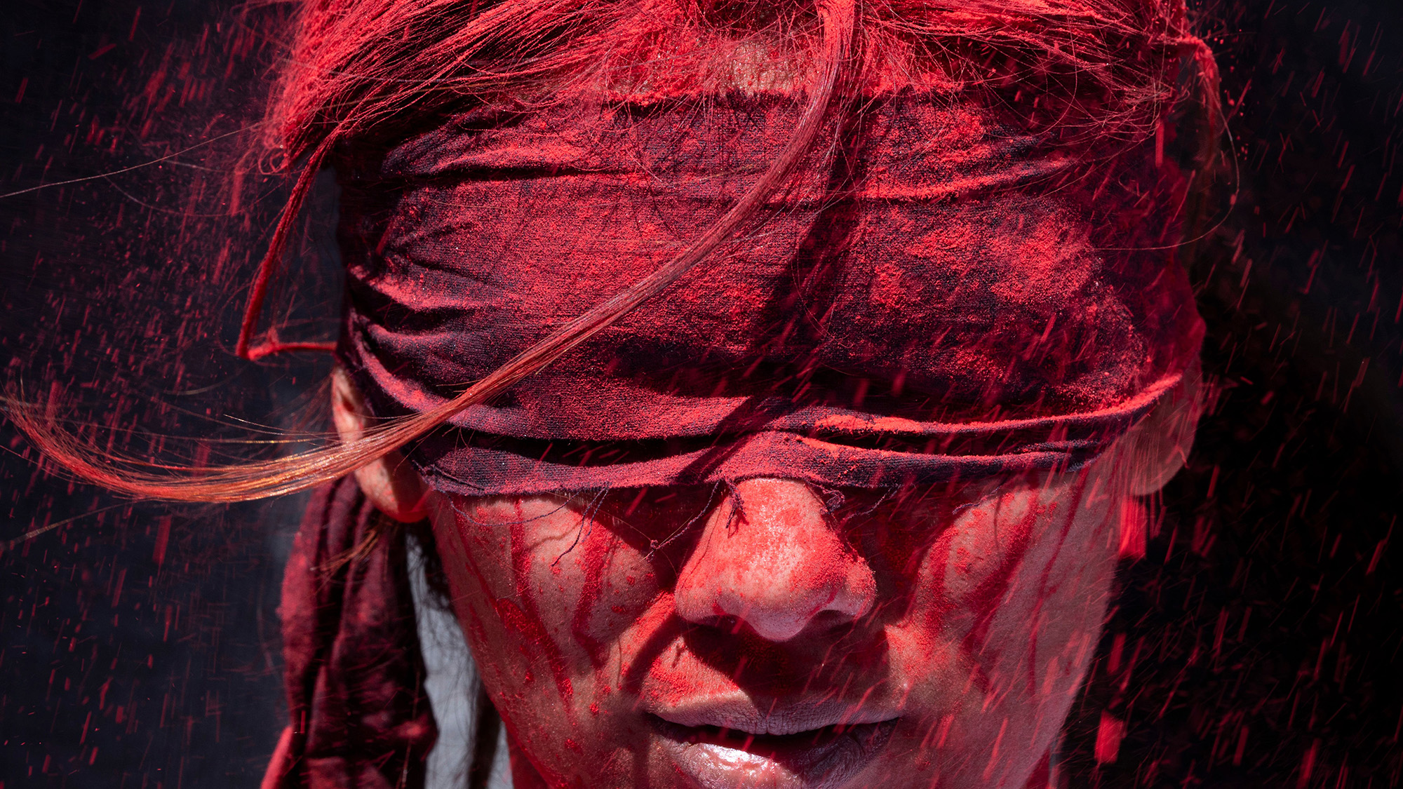 Young protestor, demanding publication of the inquiry into last year's killings by the Nepalese government, is blindfolded and covered in red powder in Kathmandu, Nepal