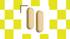 A neon tiled graphic with a pair of gold rounded foldable wall hooks 