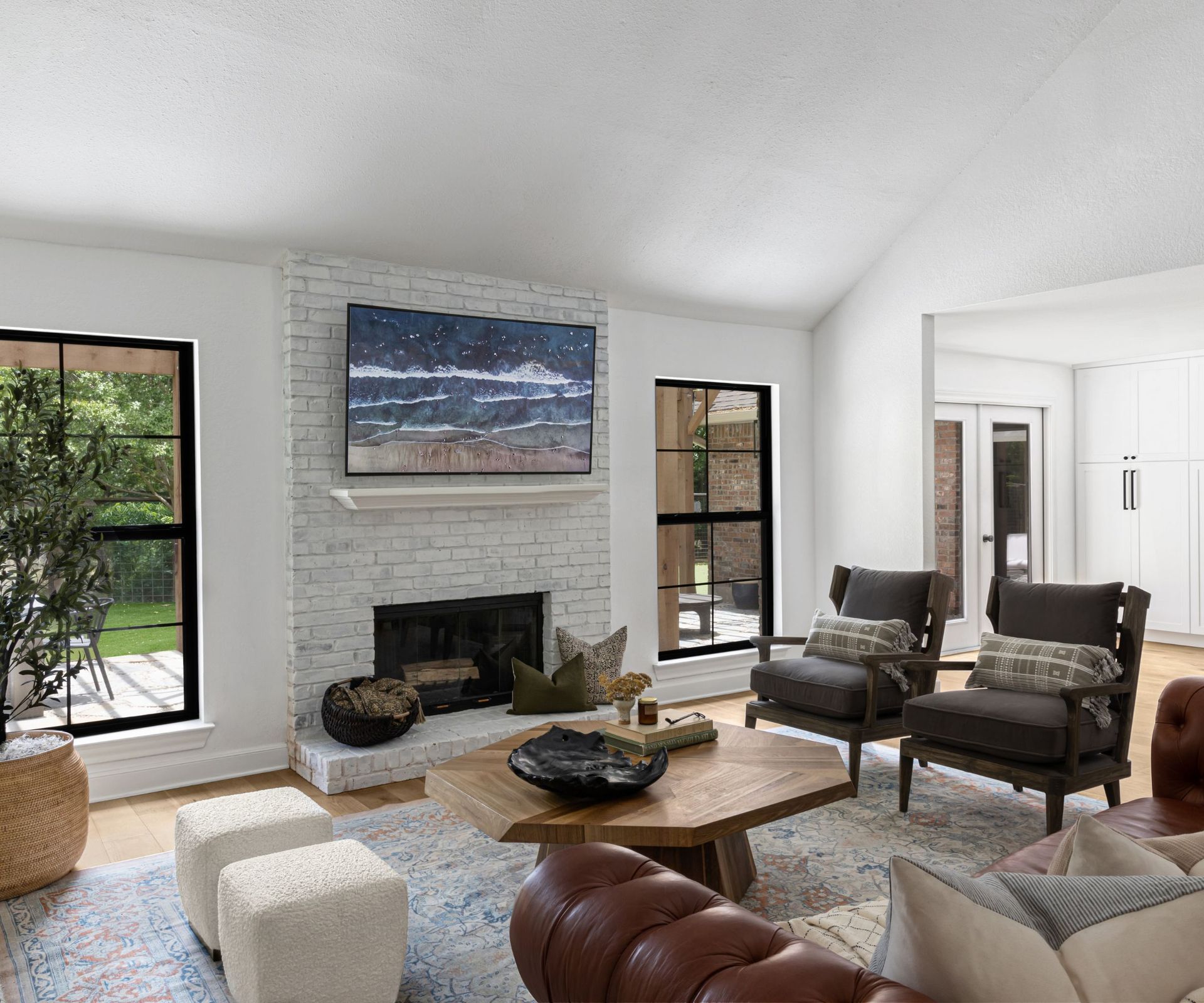 White living room with brown leather couch