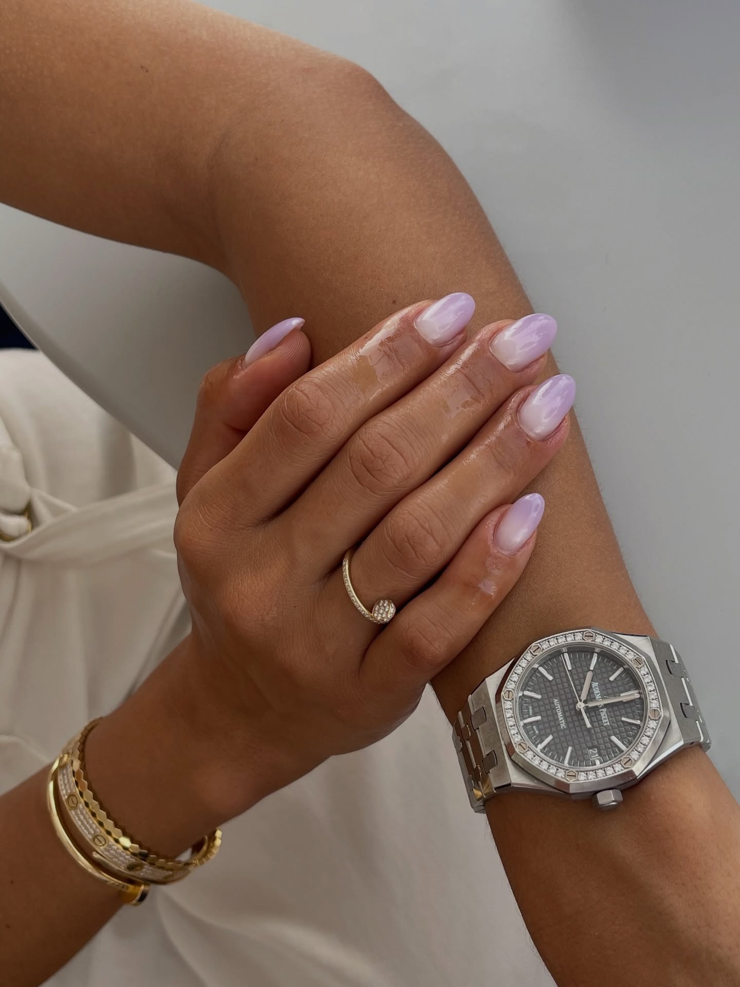 A woman with a purple ombr&amp;eacute; manicure