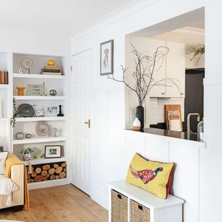 white living room with open alcove through kitchen