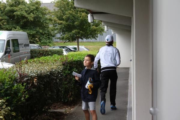 A young fans waits outside a rider's room, hoping for an autograph