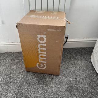 The Emma Premium mattress topper in a branded cardboard box