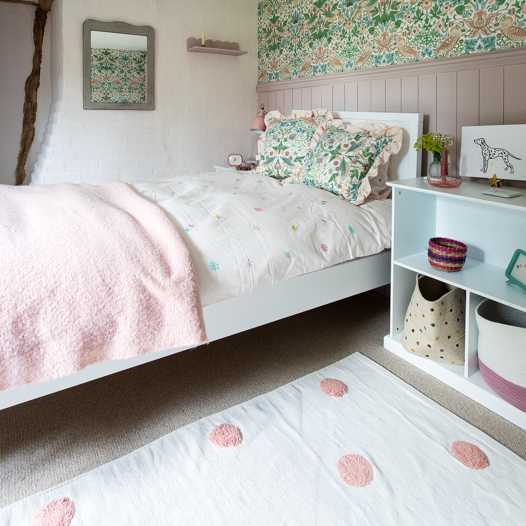 Pink bedroom with polka dot rug and basket