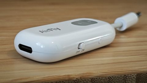 A white Twelve South AirFly Bluetooth transmitter sitting on a table