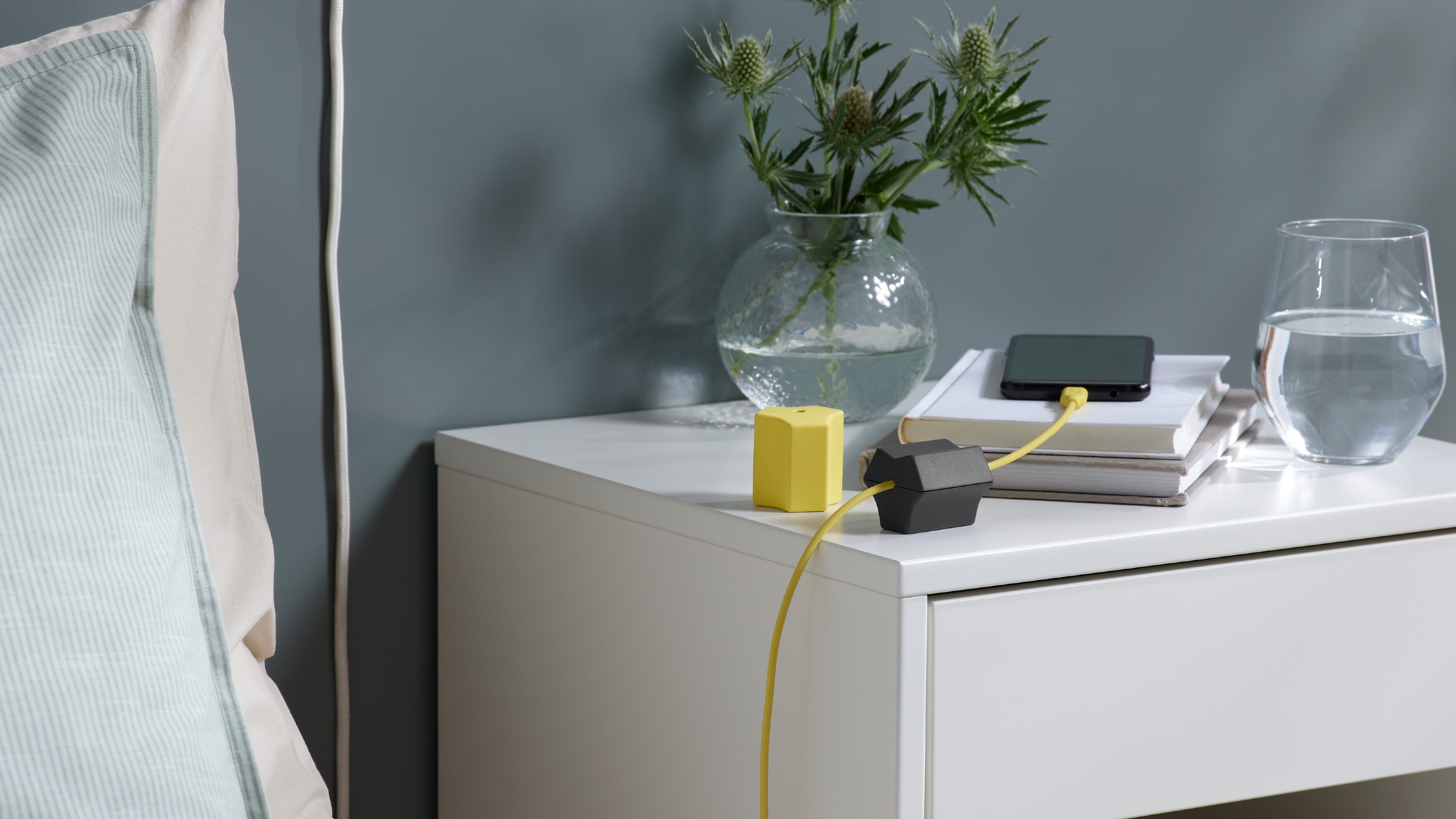 IKEA HAVSKÅL USB anchors on a white bedside table