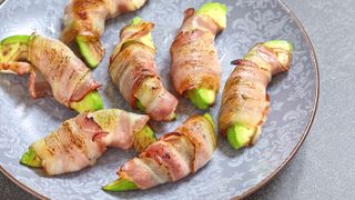 Wedges of avocado wrapped in bacon and cooked
