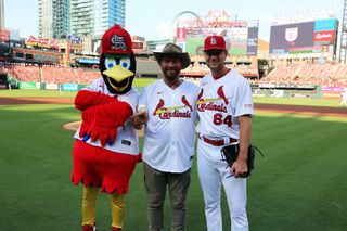 Nick Knowles with the St Louis Cardinals mascot and a baseball player.