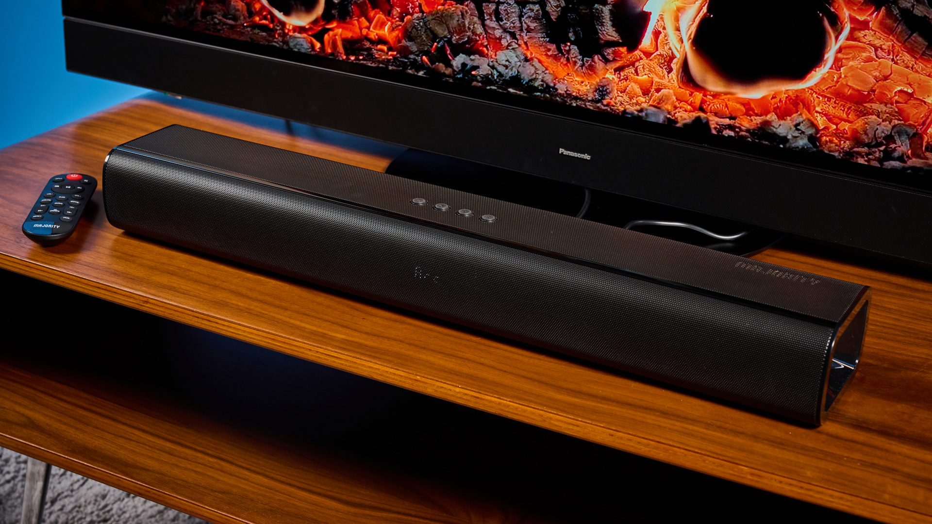 the budget majority naga 60 soundbar in black, showing its buttons and remote