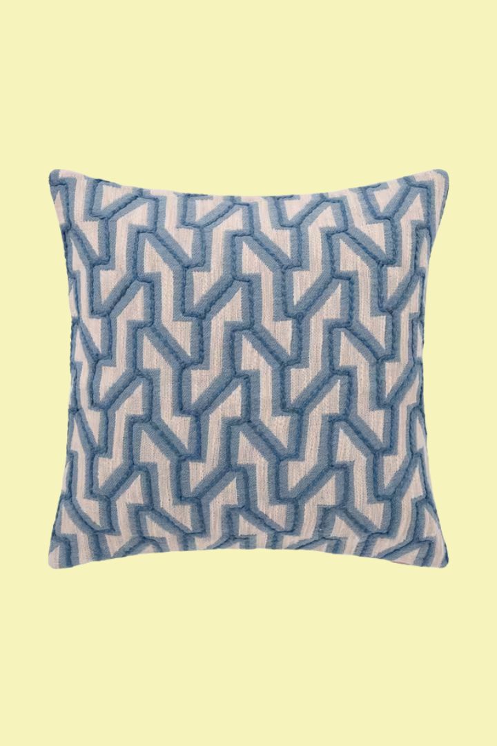 Link Cushion, Blue cushion against pale yellow background.