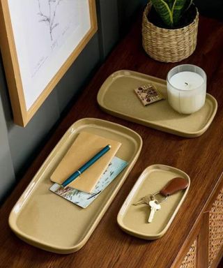 Three ceramic trays on a wooden console table