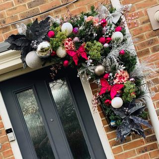 Black door with Christmas garland