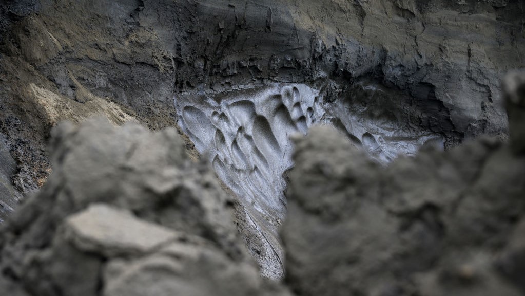 A chunk of permafrost on rocky substrate melts.