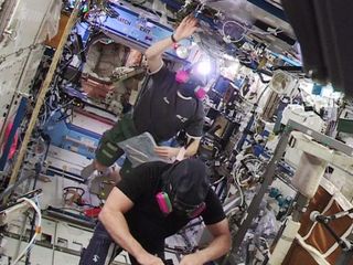 NASA Astronaut Terry Virts and European Space Agency astronaut Samantha Christoforetti reenter the U.S. segment of the International Space Station on Jan. 14, 2015 after an ammonia leak false alarm.