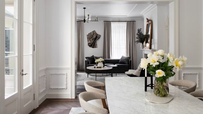 A white room with a white dado rail and panelling below