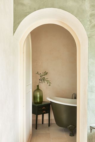 Elegant bathroom with green roll top bath in 16th century French townhouse in Saint-Paul de Vence