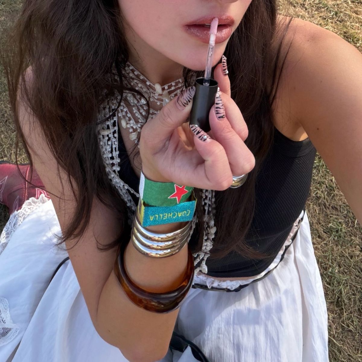 An image of Alyssa Brascia applying lip gloss.
