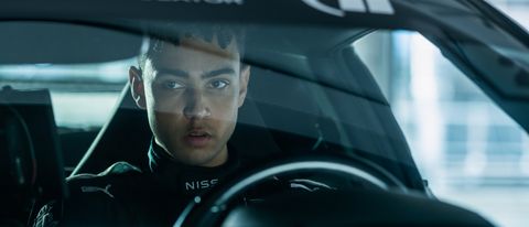 Archie Madekwe sits behind the wheel in Gran Turismo.