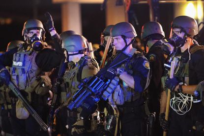 Police in Ferguson came under 'heavy gunfire' last night, commander says
