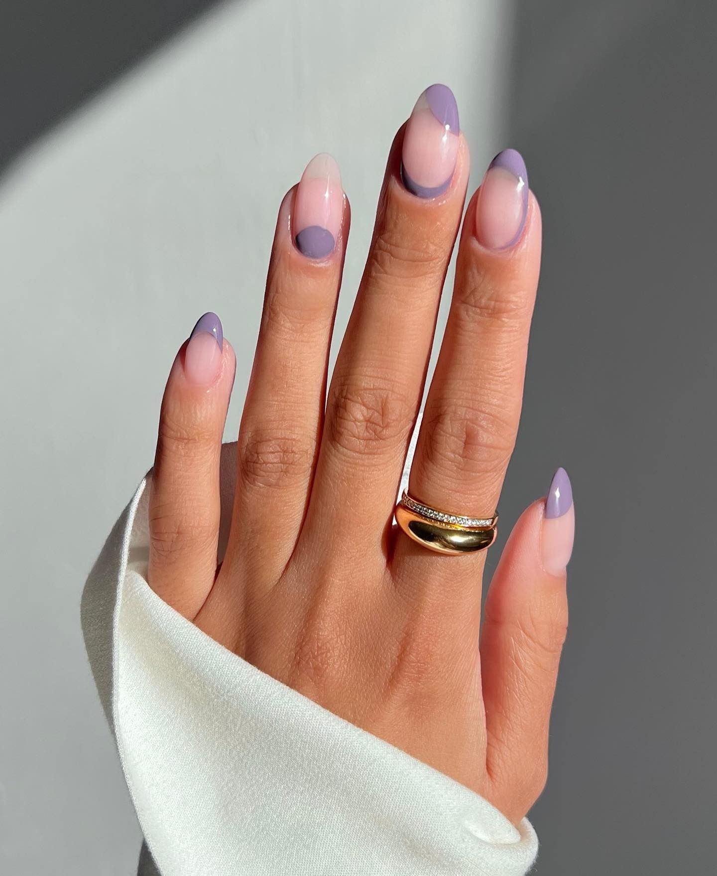 A picture of a purple negative space nail design