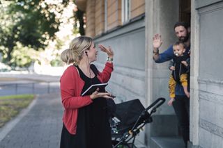 Mid adult mother waving family while leaving for work - stock photo