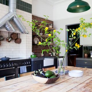 kitchen with wooden dining set and white tiles