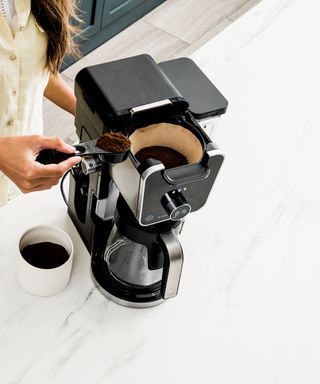 Coffee machine on a white marble countertop