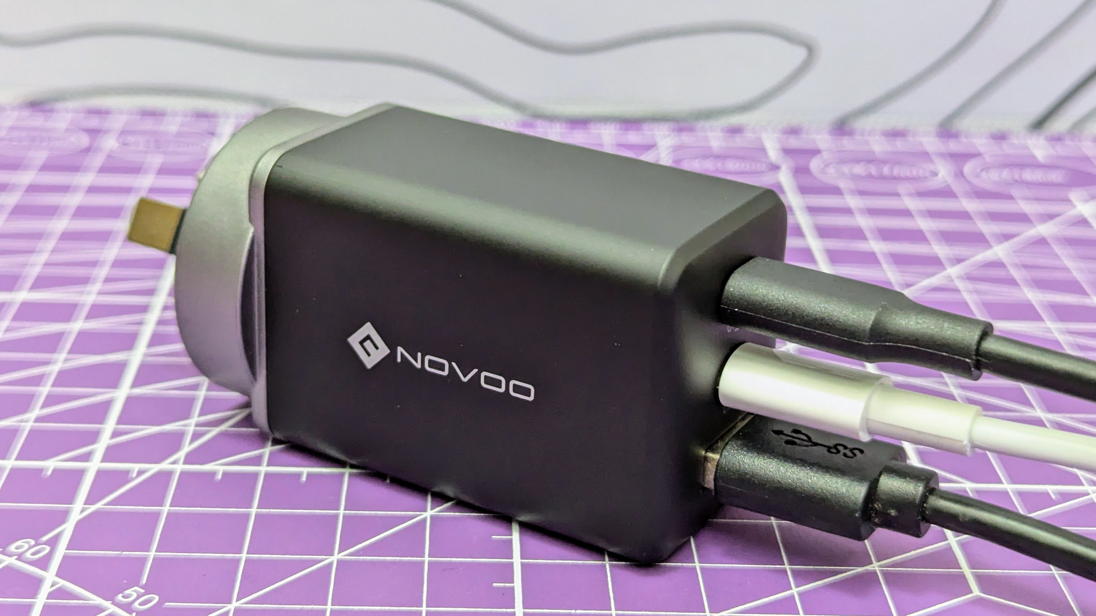 Novoo RG68 USB-C charger with three plugged in USB cables