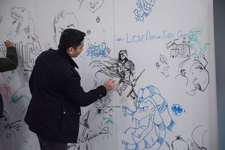 Man drawing a fantasy warrior on a wall of art
