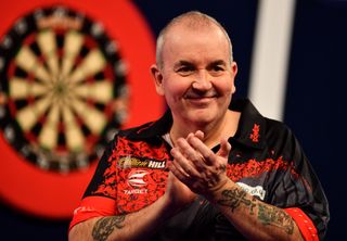Phil Taylor celebrates after winning his Third Round Match against Keegan Brownduring the 2018 William Hill PDC World Darts Championships