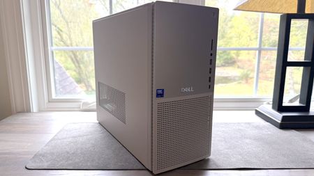 Dell Tower Plus desktop resting on a desk in front of a window