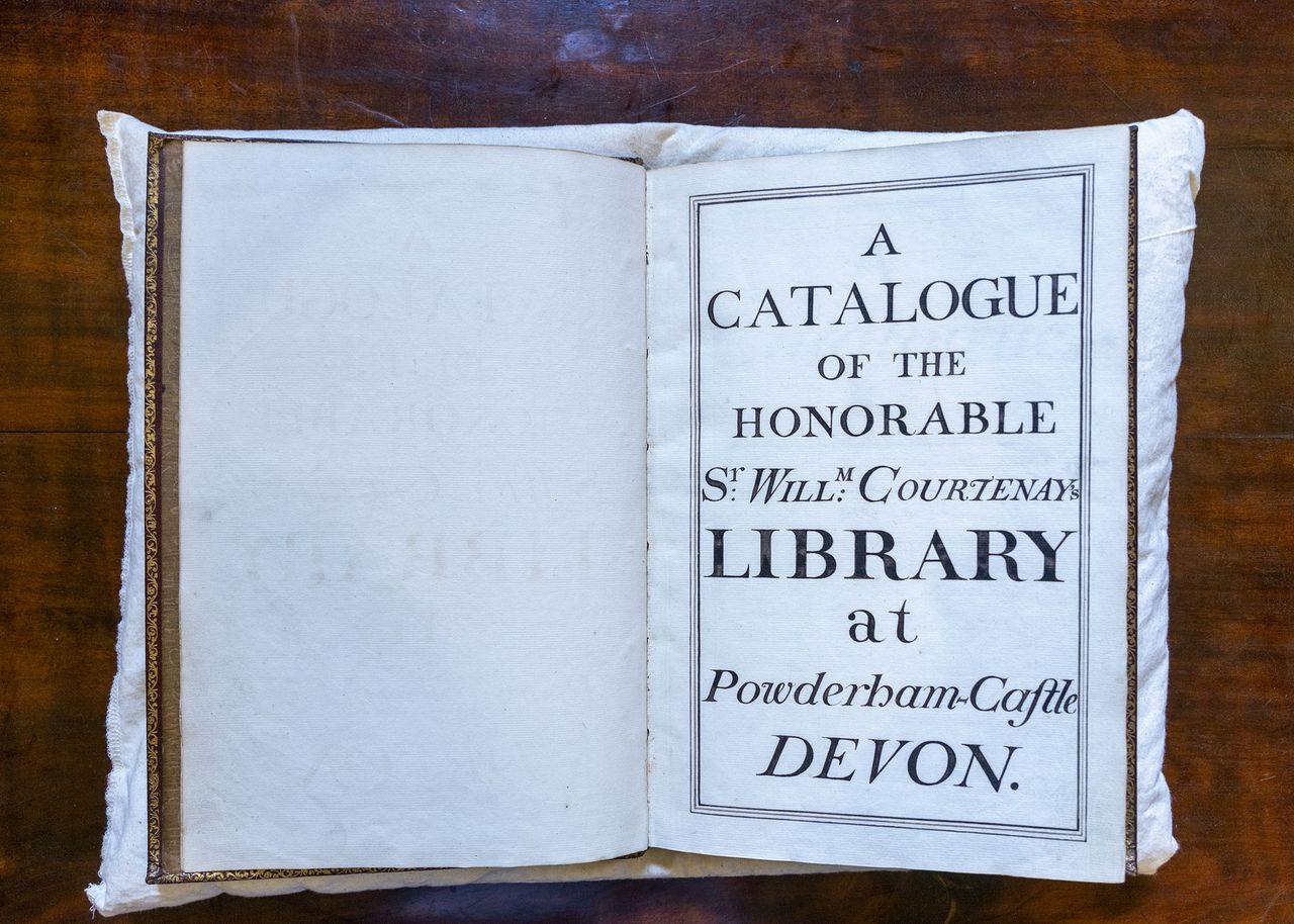 Charlie Courtenay, 19th Earl of Devon with his ancestor's book at Powderham Castle.