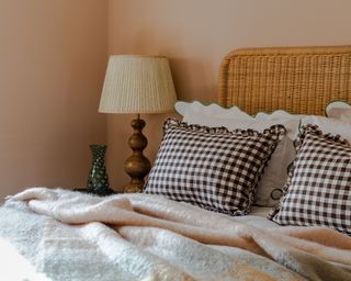 spring bedroom with gingham pillows and lamp