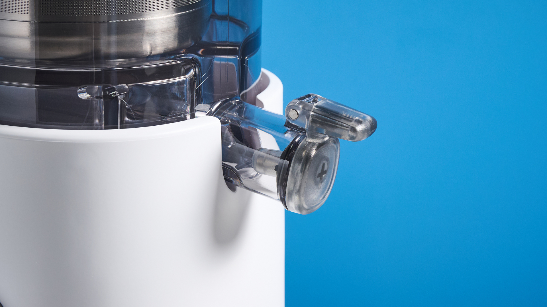 the nama m1 plant-based milk maker in white with a pitcher, blade frame, and strainer, and a pulp mat accessory with a brush