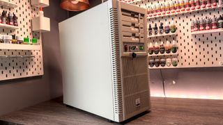 The retro-styled Silverstone FLP02 PC case as a PC is being built into it on a desk.