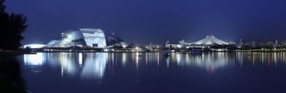 Panoramic view of sports hub at night next to river