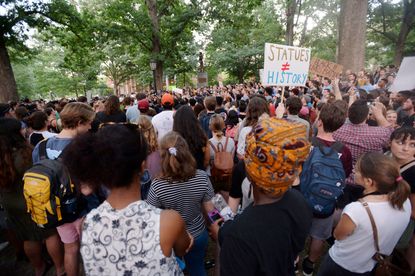 Demonstrators rally for the removal of a Confederate statue, coined Silent Sam, on the campus of the University of Chapel Hill on August 22, 2017 in Chapel Hill North Carolina. 