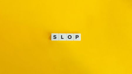 Letter game tiles spell out the word "slop" on a yellow background