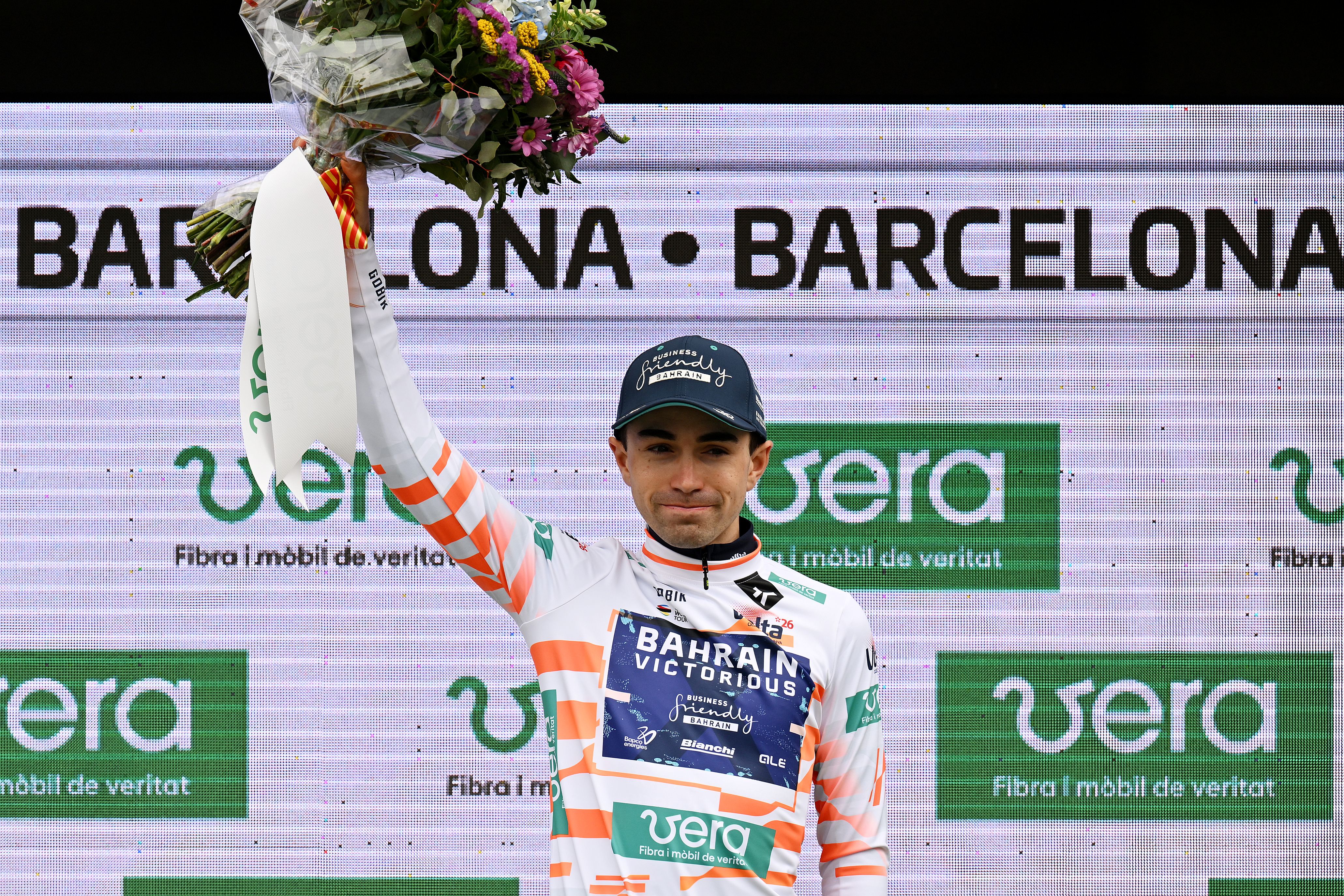 BARCELONA, SPAIN - MARCH 29: Lenny Martinez of France and Team Bahrain - Victorious celebrates at podium as Orange Young Jersey winner during the 105th Volta a Catalunya 2026, Stage 7 a 95.1km stage from Barcelona to Barcelona / #UCIWT / on March 29, 2026 in Barcelona, Spain. (Photo by Szymon Gruchalski/Getty Images)