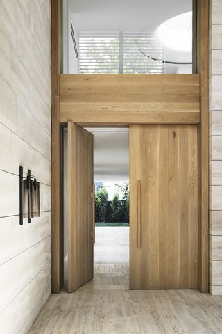 Large wooden double door at villa entrance