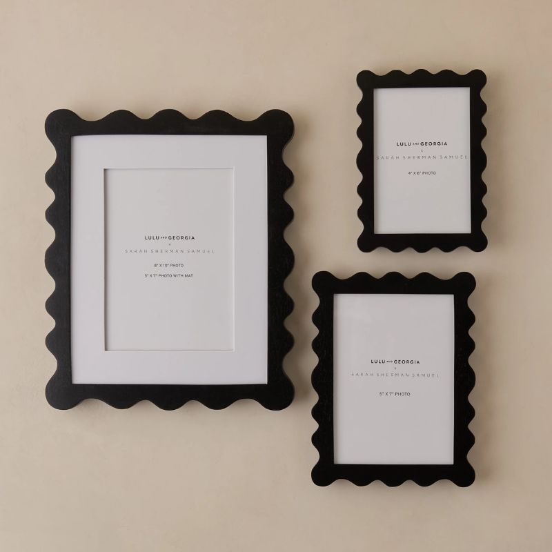 set of three black photo frames with wavy edges