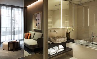 A bathroom and lounge area in a room at Hotel Viu — Milan