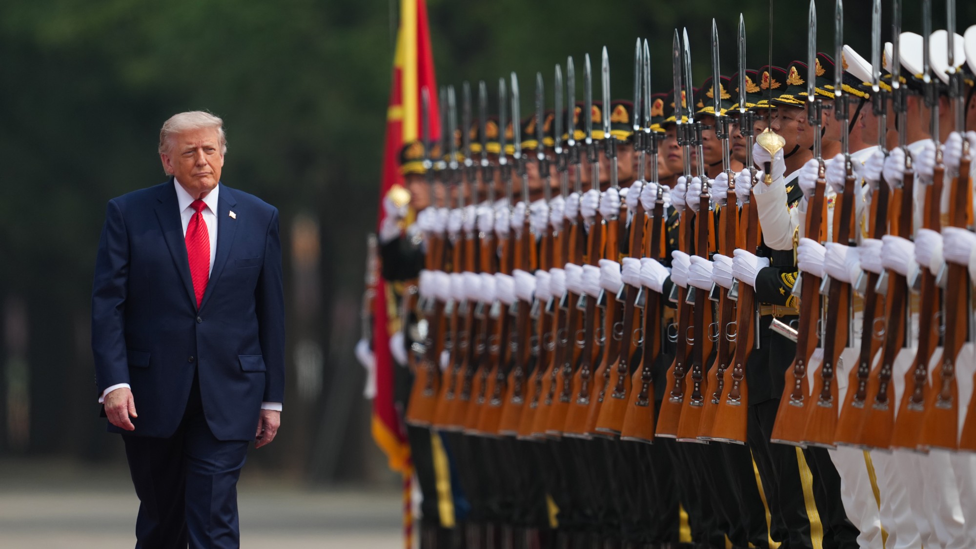 Donald Trump walks past a line of Chinese soldiers at attention on his state visit to China