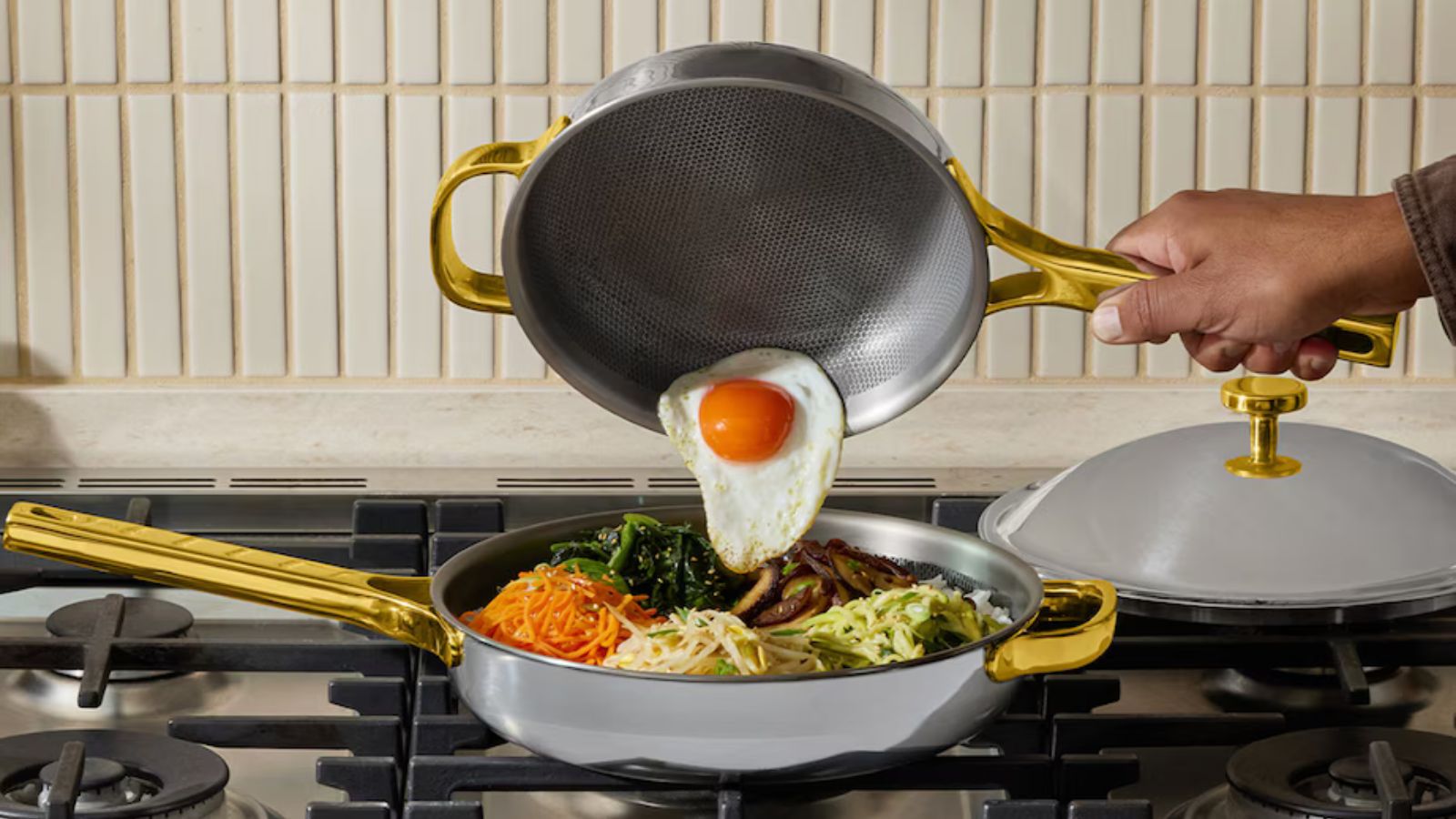 Titanium Always Pan® Pro Pan, tipping a fried egg on top of a bibimbap dish