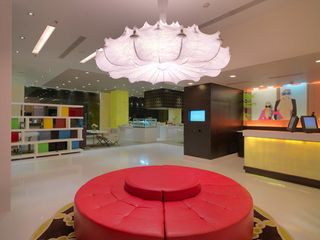 Peppermint hotel lobby with pink circular seating and chandelier