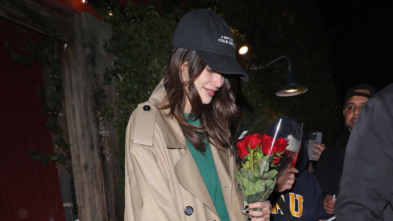 Kaia Gerber leaving a show with a trench coat and the row mary janes